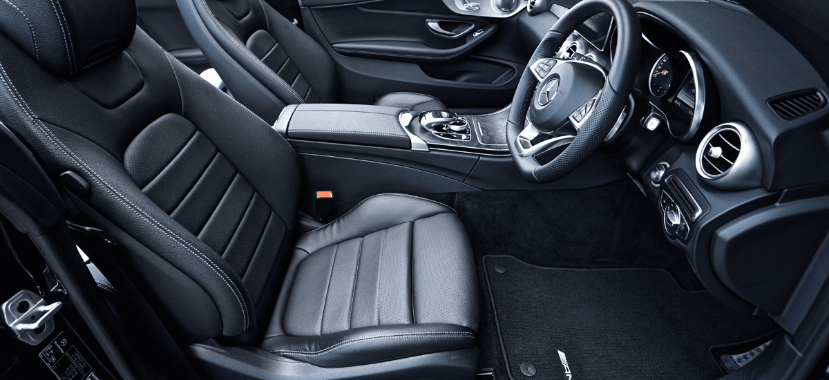 Modern luxury car interior with leather seats and advanced dashboard features.