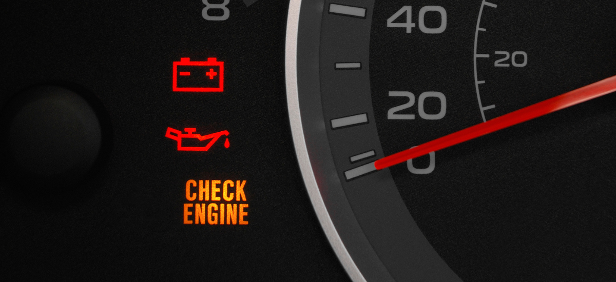 Car dashboard showing check engine light and oil warning indicator.