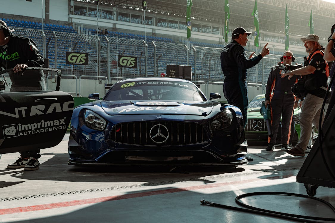 Mercedes-Benz race car in the pit lane at a racing event.