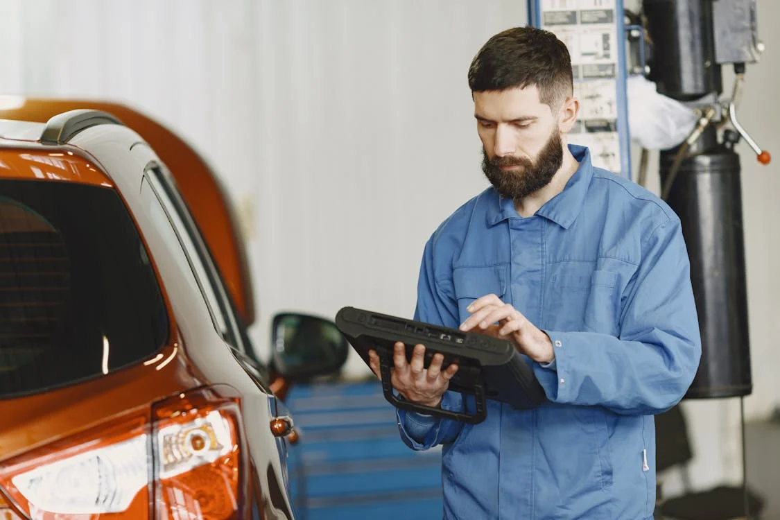 Skilled mechanic performing vehicle diagnostics at Westmoreland’s top European car repair shop.