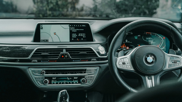 Close-up of BMW dashboard showing climate control and infotainment system.