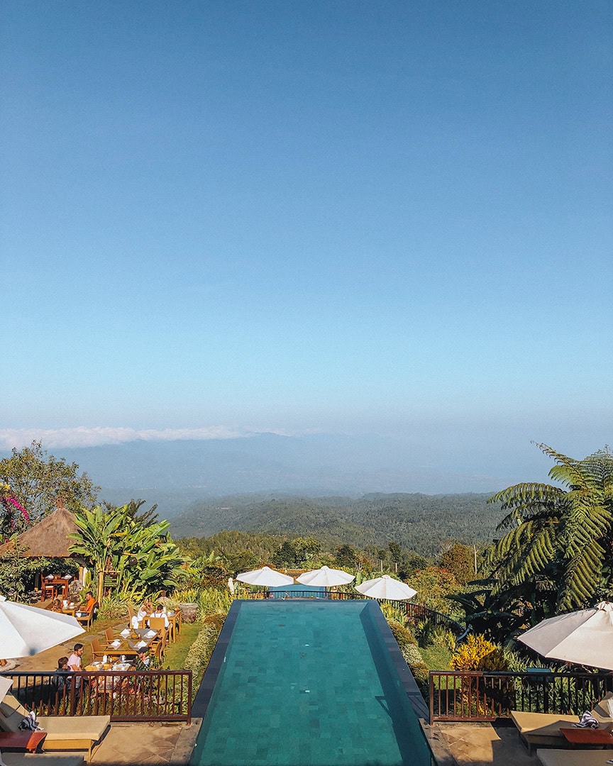 A stunning infinity pool overlooking a vast, mountainous landscape. Munduk Moding Plantation.