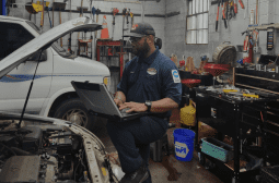Skilled auto repair technician diagnosing vehicle issues in the workshop.