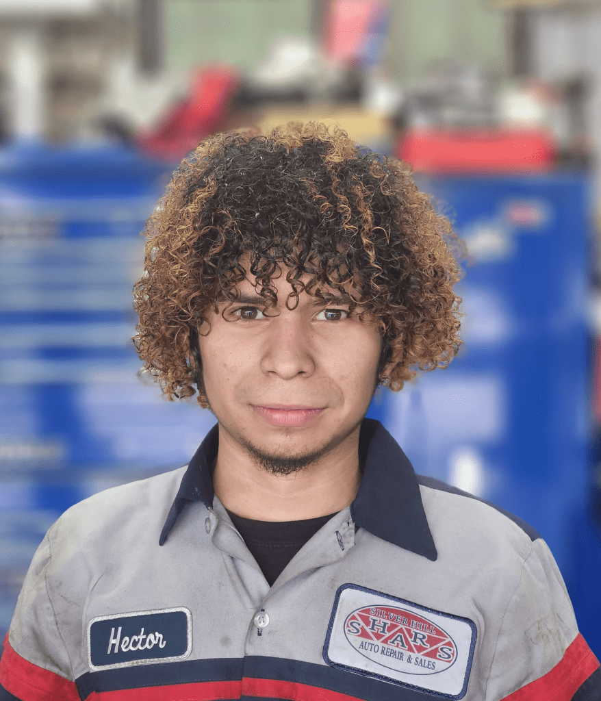 Auto repair technician in uniform at Silver Hill Auto Repair shop.
