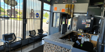 Auto repair shop waiting area with seating and large windows.