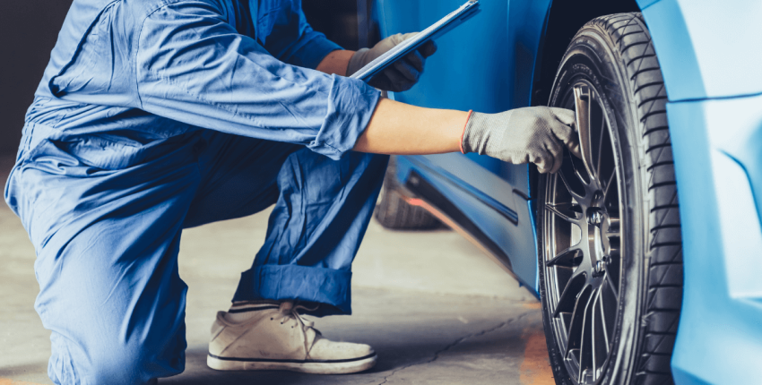 Technician inspecting a car tire during maintenance at Silver Hill Auto Repair.