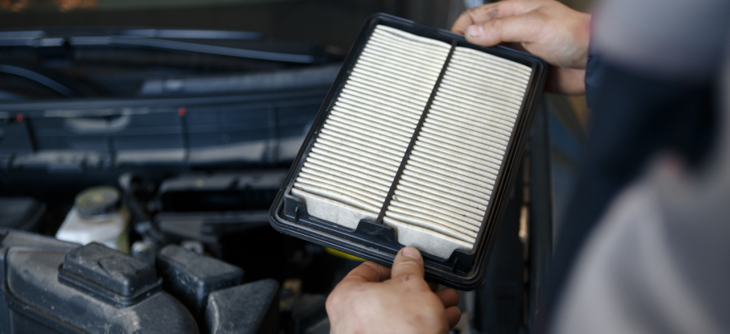 Car air filter being checked during routine maintenance.