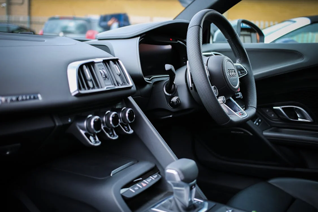 Car dashboard with warning lights and controls for vehicle maintenance.