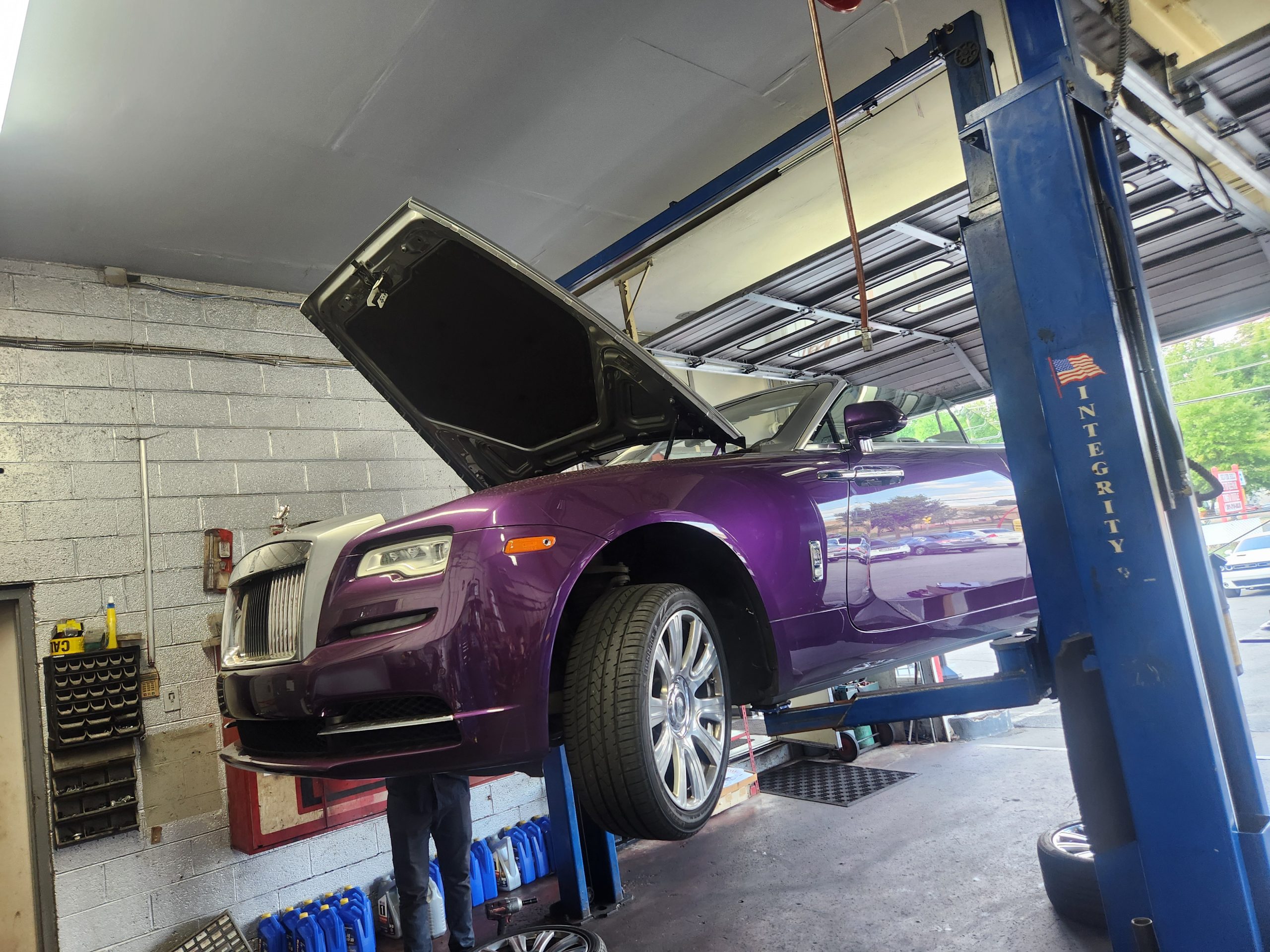Purple luxury car elevated on lift at Silver Hill Auto Repair.