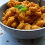 Creamy buffalo chicken dip, spicy and flavorful, served in a gray bowl with fresh basil garnish, perfect for appetizers or game day snacks.