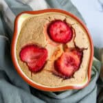 Fresh strawberry cobbler in a heart-shaped baking dish, featuring a golden crust and vibrant strawberry topping, perfect for spring or summer dessert recipes.