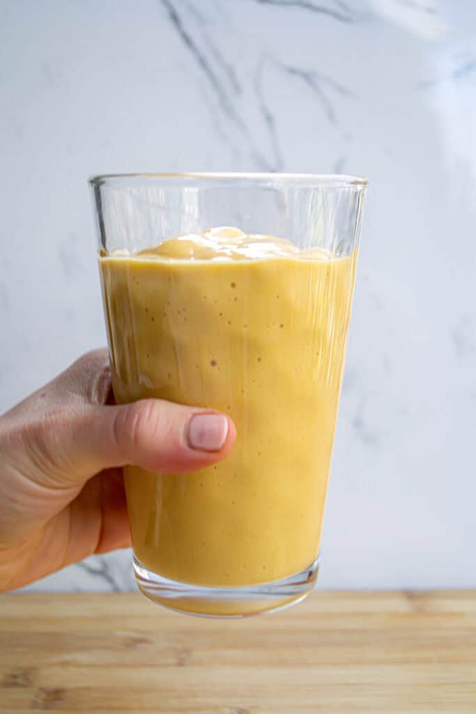 Creamy mango smoothie with fresh fruit and natural ingredients, perfect for a healthy breakfast or snack. Made with ripe mangoes, yogurt, and a touch of honey for a delightful flavor.