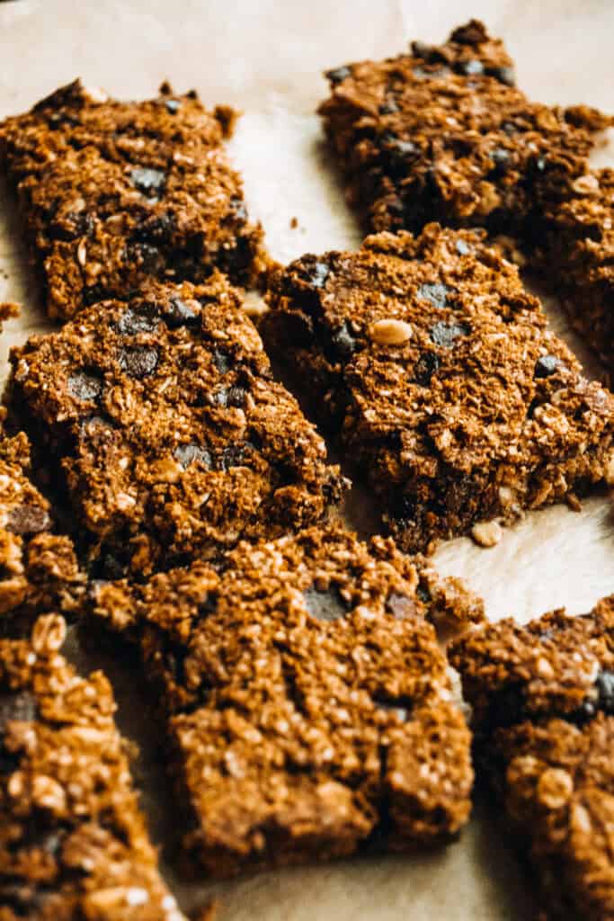 Chocolate chip granola bars on parchment paper, made with oats, nuts, and chocolate chips for healthy snacking, easy to store and perfect for on-the-go breakfast.