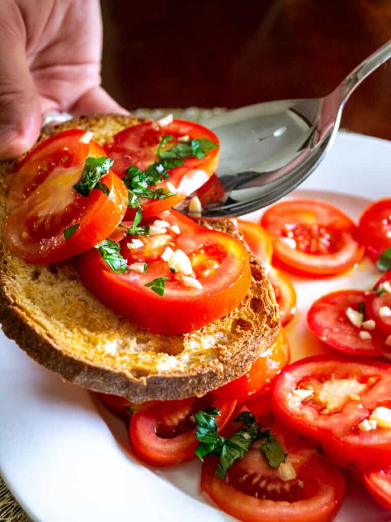 Fresh tomato bruschetta with chopped basil and garlic on crusty bread, featuring vibrant heirloom tomatoes and herbs, perfect for a healthy, simple appetizer or snack.