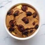 Creamy vegan ice cream topped with dried cranberries, served in a white bowl. Perfect for gluten-free, dairy-free, and plant-based dessert lovers seeking delicious, healthy treats.