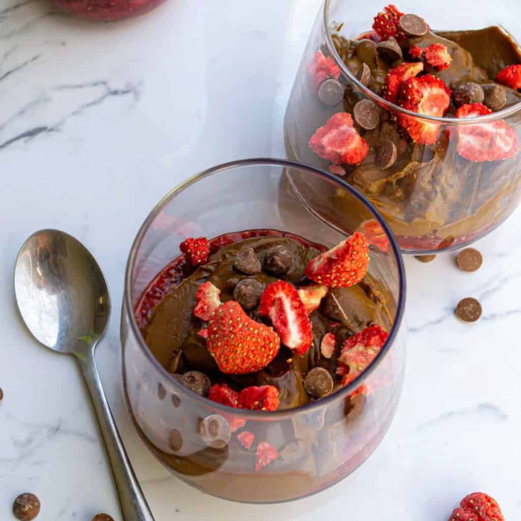 Rich chocolate pudding topped with fresh strawberries and chocolate chips in elegant glass dessert cups. Perfect for a decadent, fruity treat or dessert for any special occasion.