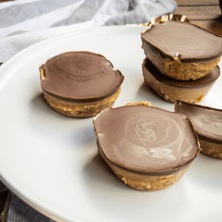 Creamy chocolate peanut butter cups on a white plate, perfect for homemade treats and dessert recipes. Delicious, rich, and easy to make with peanut butter and chocolate.