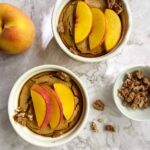 Two ramekins of peach baked oatmeal.