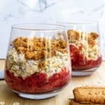 Fresh layered dessert in Glasses with strawberries, creamy filling, and crunchy cookie topping, perfect for summer recipes and healthy treats.
