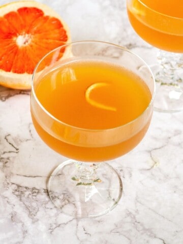 Overhead shot of grapefruit daiquiri in a crystal glass.