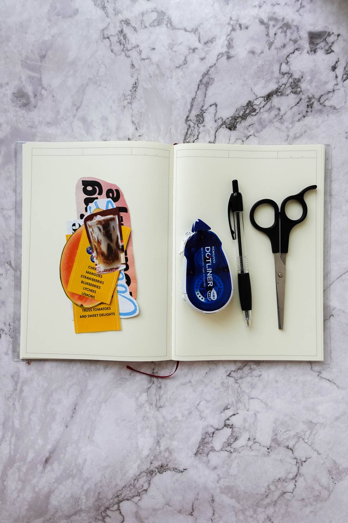 Flatlay showing what you need to make a cooking journal including a blank journal, magazine cutouts, a dot liner adhesive, a pen, and scissors.