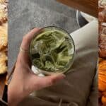 Refreshingly green iced matcha latte with ice cubes, showcasing a healthy, trendy beverage.