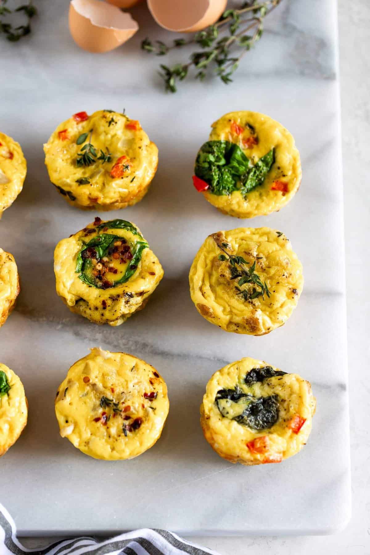 Breakfast egg muffins with spinach, red peppers and herbs