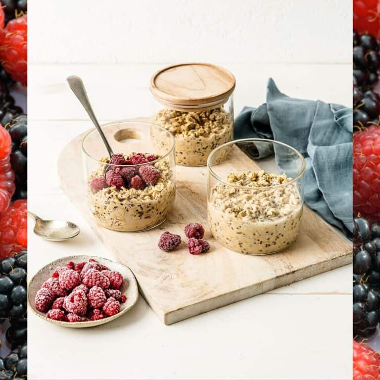 Three jars of overnight oats topped with raspberries.