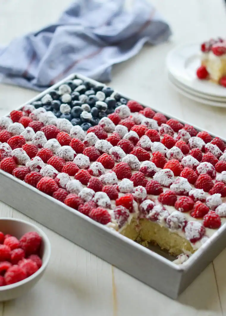 Freshberry trifles with layered sponge cake, whipped cream, and ripe mixed berries in a rectangular tray, perfect for summer desserts and berry recipes.
