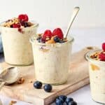 Creamy overnight oats in glass jars, topped with berries light background for healthy breakfast recipes, perfect for breakfast or snacks.