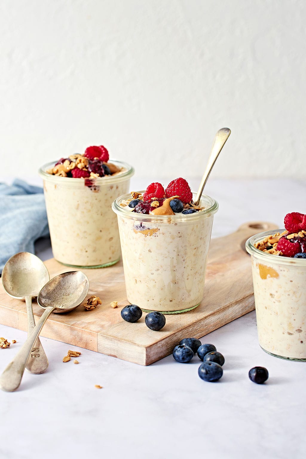 Creamy overnight oats in glass jars, topped with berries light background for healthy breakfast recipes, perfect for breakfast or snacks.
