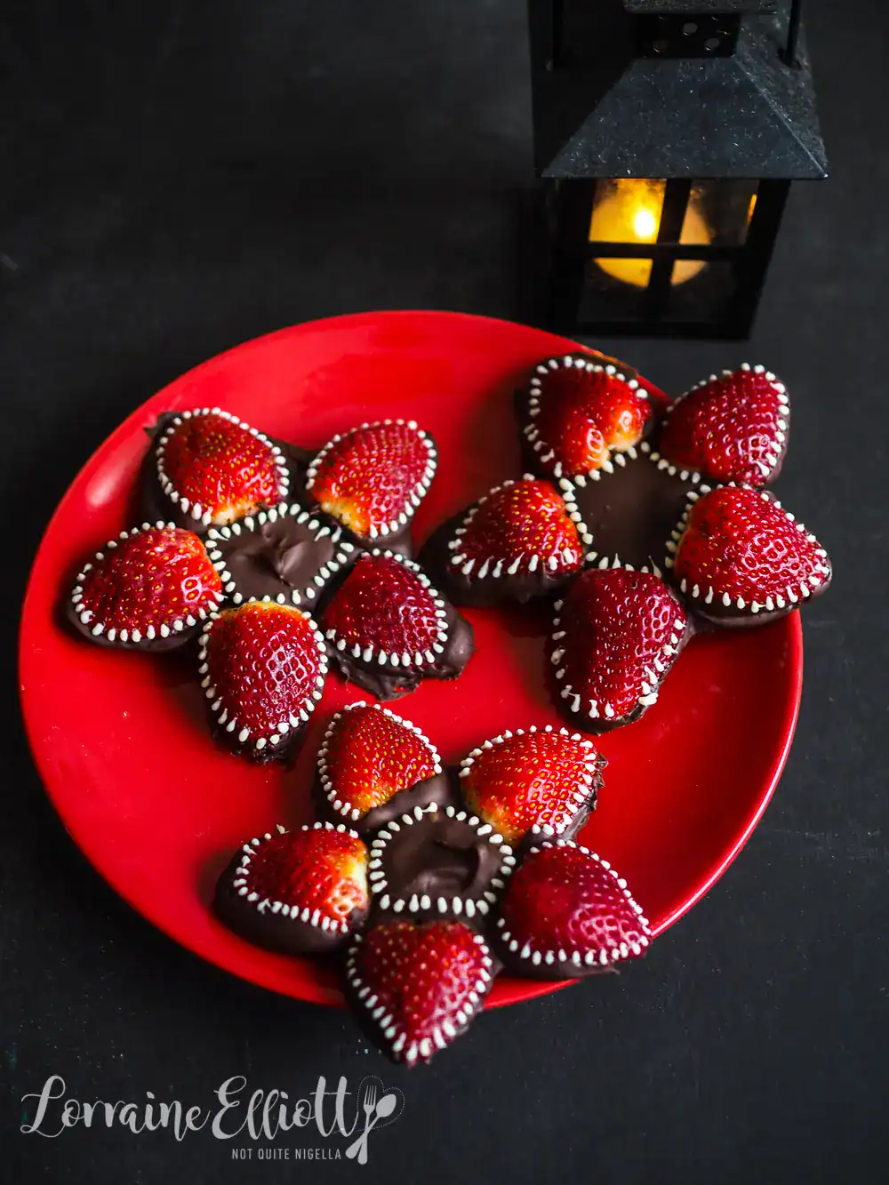 Demogorgon chocolate strawberries on a red plate.