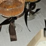 New Year's party champagne cocktails in fancy glasses with black ribbons around the stem.