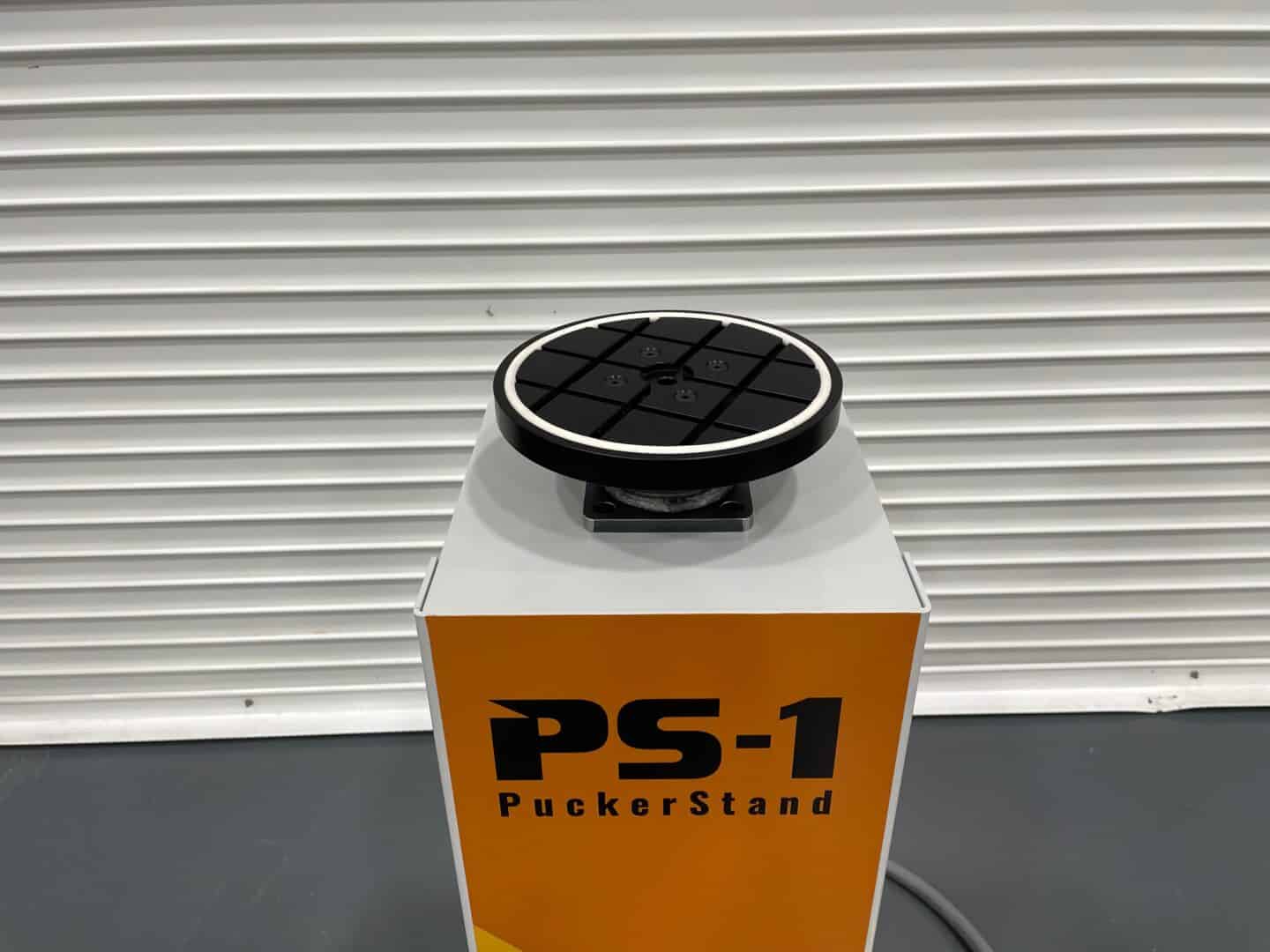 High-tech puck stand device for sports and gaming applications at SNX Technologies.