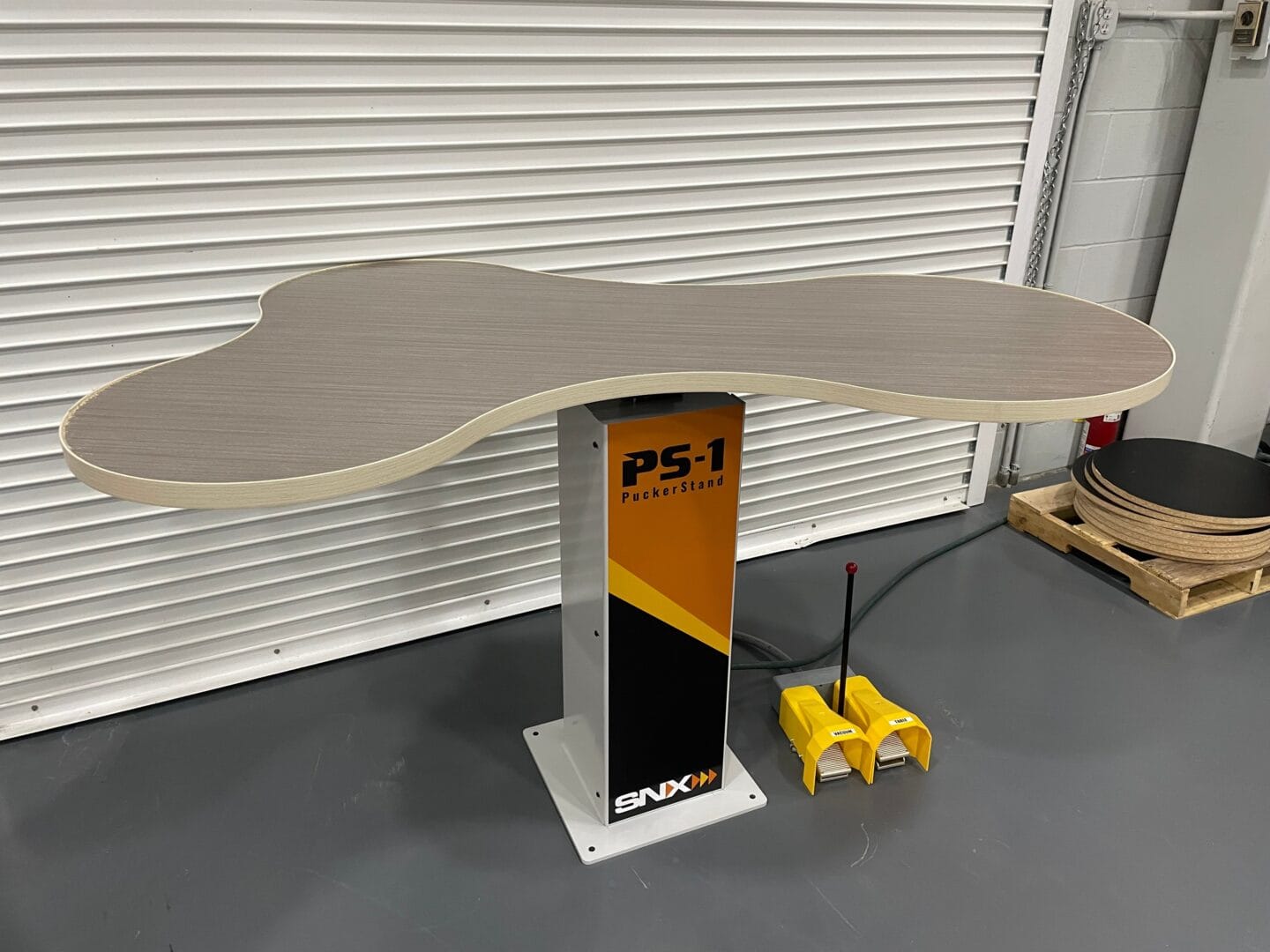 PuckerStand for ice hockey training with a wood rink and skating pad.