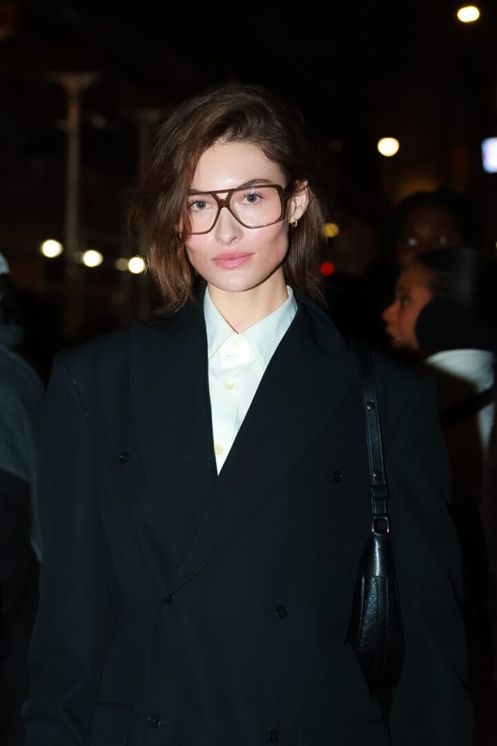 Chic guest in oversized black blazer and glasses at NYFW evening event