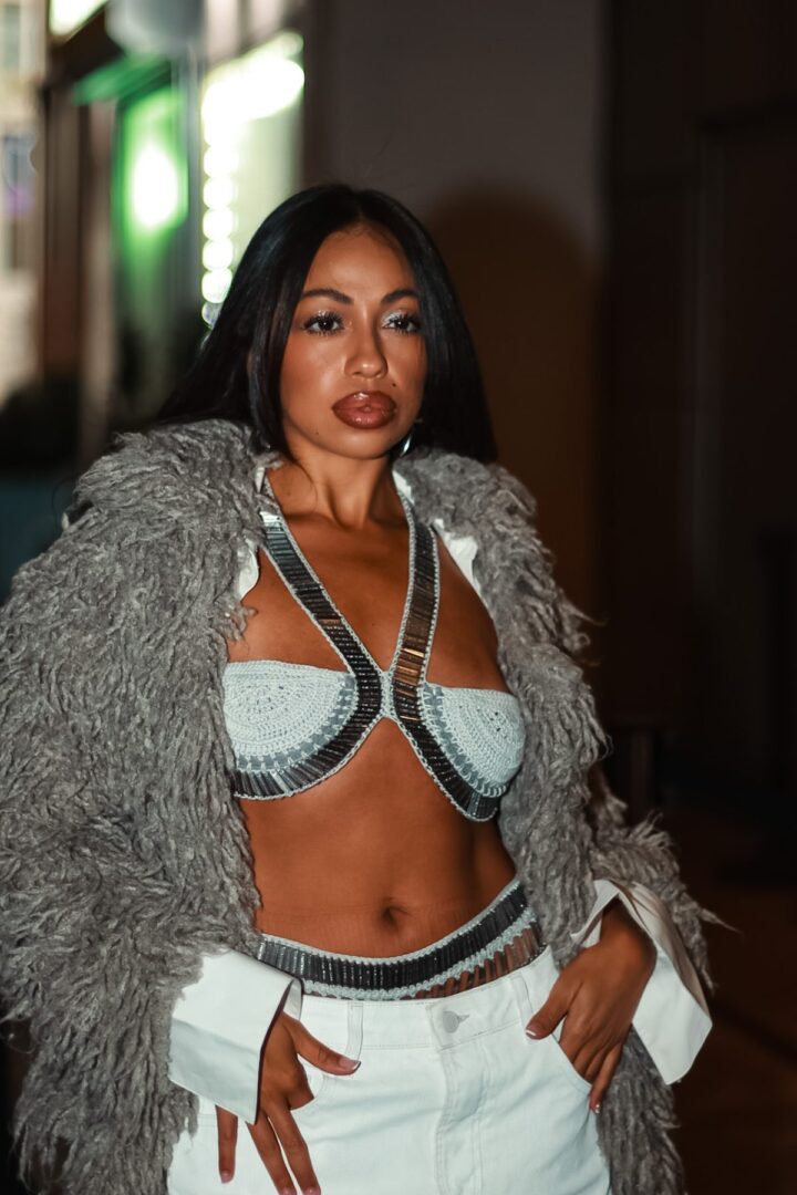 Bold street style look featuring silver crochet bralette and shaggy fur coat during NYFW