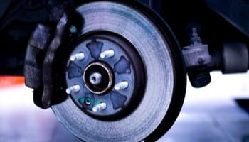 Close-up of brake disc and caliper for automotive brake repair services.