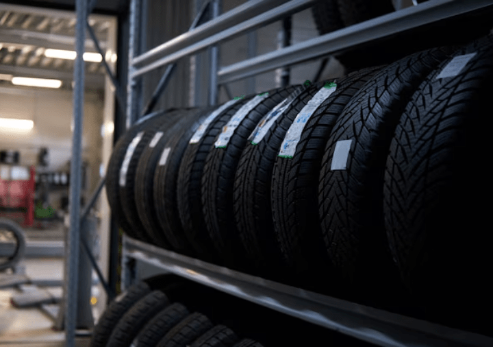 New tires displayed on shelves at Tatlow Tire store in 2024.
