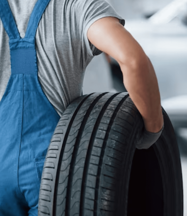 Technician installing new tires at Tatlow Tire shop in 2024.