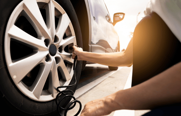 Car tire being checked or inflated at Tatlow Tire in 2024.