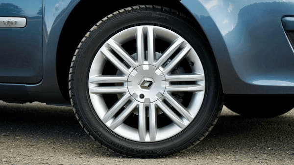 Car tire with alloy wheel, emphasizing tire rotation importance for vehicle maintenance.