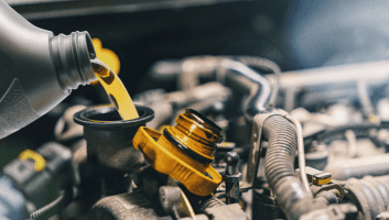 Oil change being performed on a vehicle engine at Teays Valley Auto Service Center.