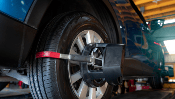 Wheel alignment being performed on a vehicle at Teays Valley Auto Service Center.