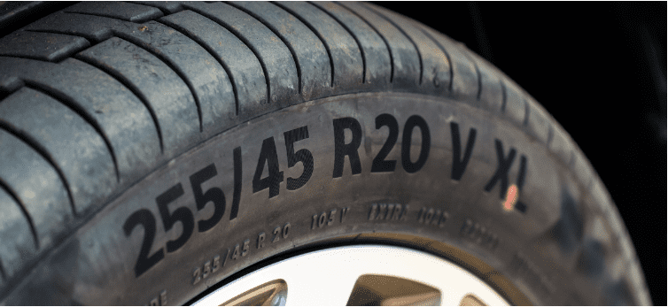 Close-up of a car tire with size 255/45 R20 V X markings.