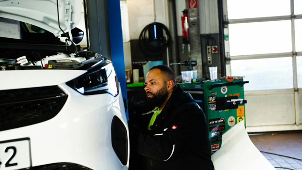 Auto technician performing vehicle inspection at Teays Valley Auto Service Center.