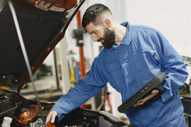 Auto mechanic performing vehicle inspection for safety and maintenance.