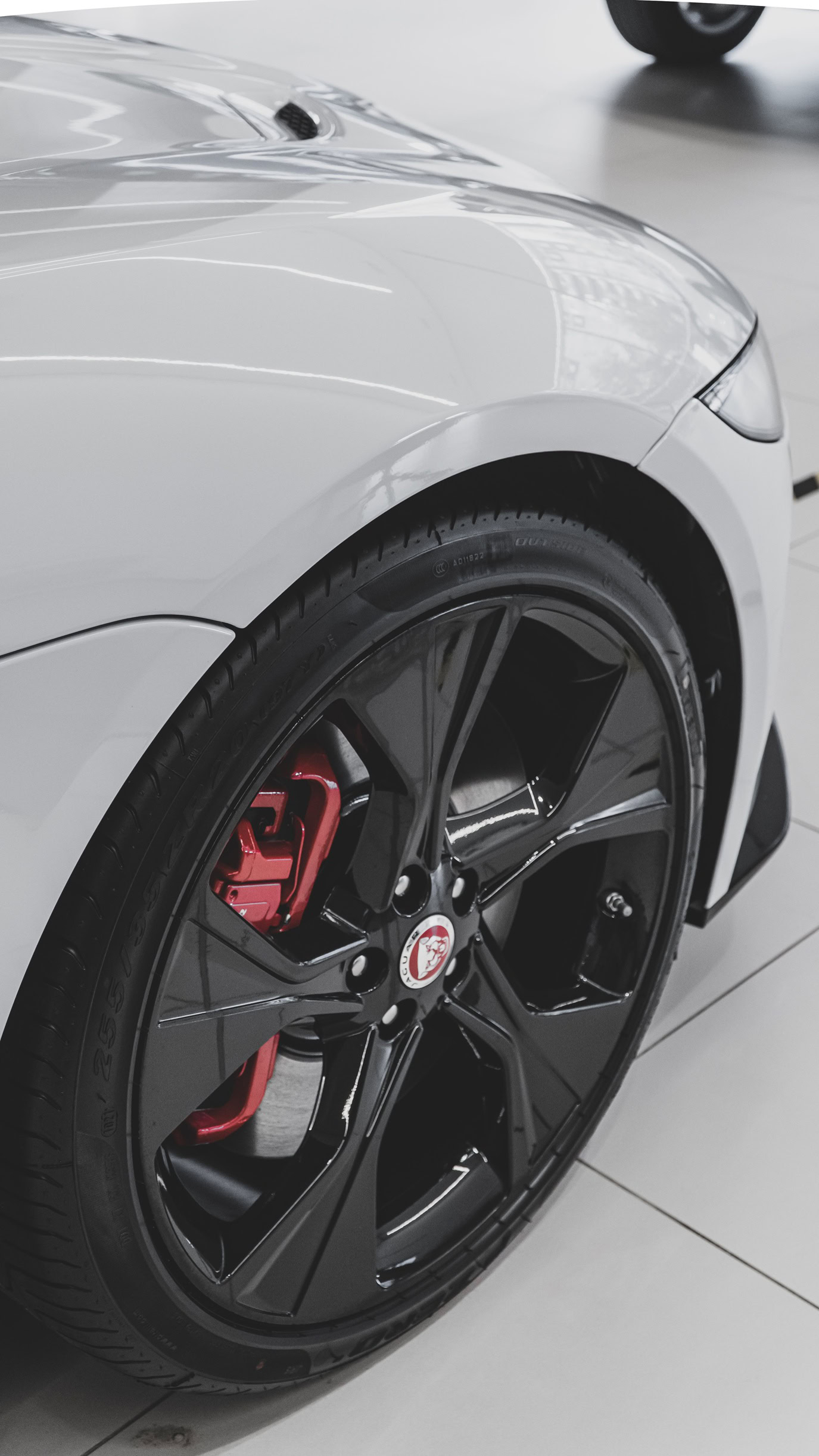 Close-up of a sleek car wheel with black rim and red brake caliper in Hurricane WV.