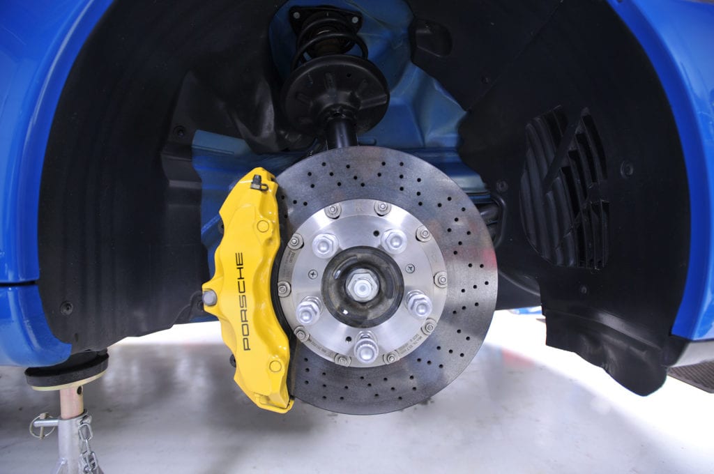 High-performance brake caliper and disc rotor in a vehicle.