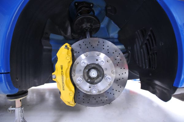 High-performance brake caliper and disc rotor in a vehicle.